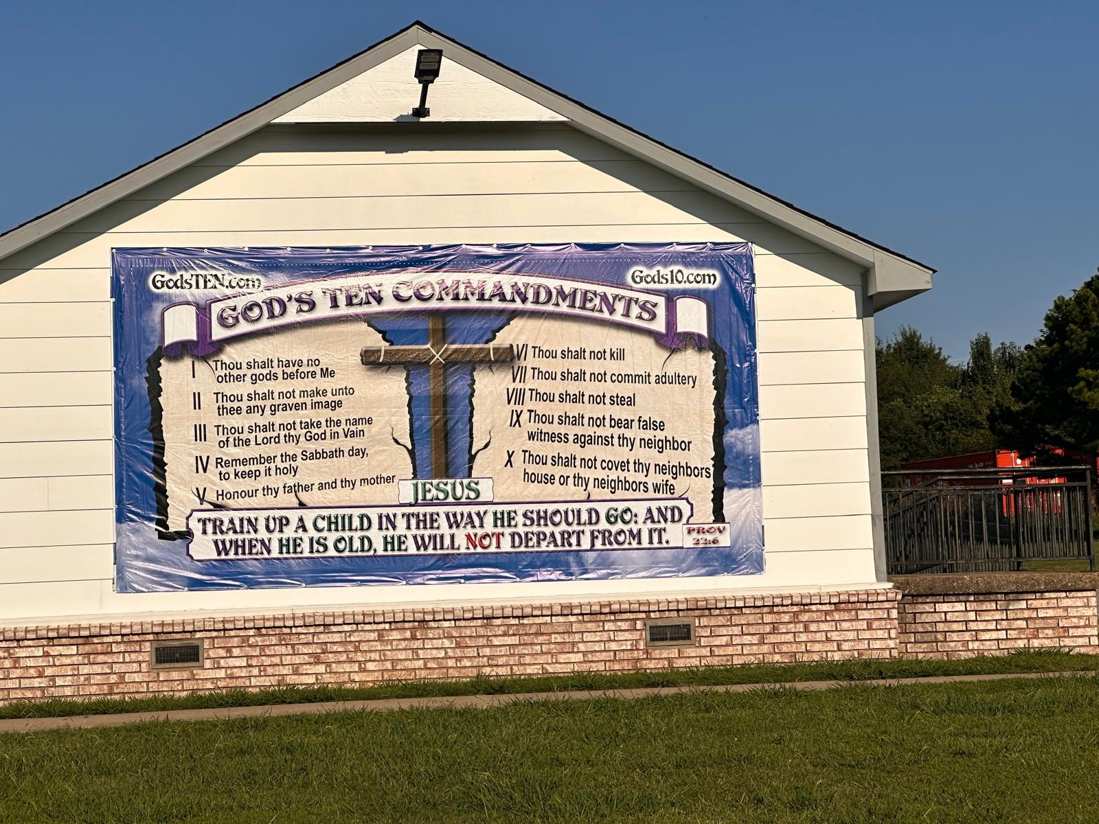 God's Ten Commandments banner mounted on the gable end of a building