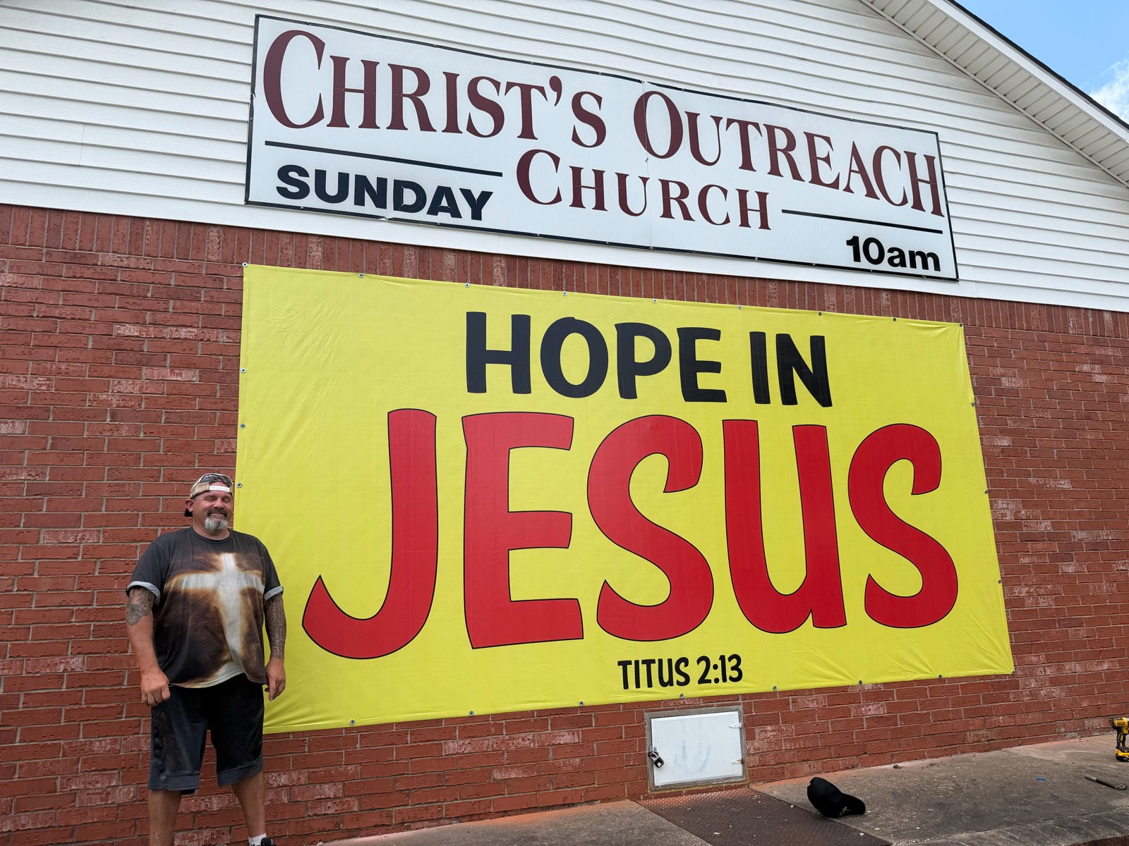 A HOPE IN JESUS banner, Titus 2:13, freshly hung on the brick wall of Christ's Outreach Church