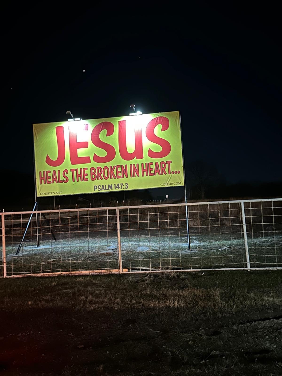 A JESUS heals the broken in heart banner lit up at night, Psalm 147:3