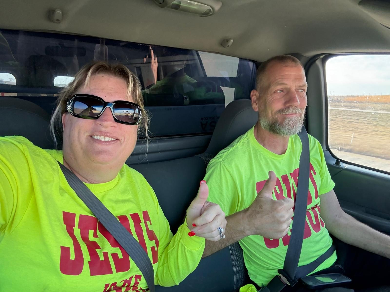 Steve Sawyer and his wife Carrie in their JESUS shirts, laboring together for Banners for Jesus